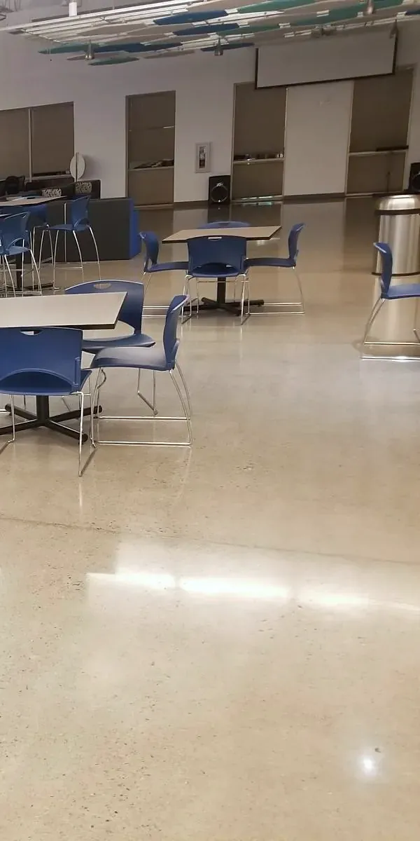 Break room with blue chairs and a polished concrete floor