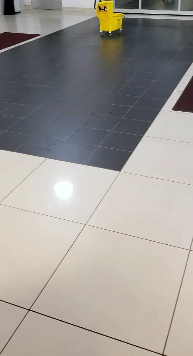 Yellow mop bucket on a clean tile floor